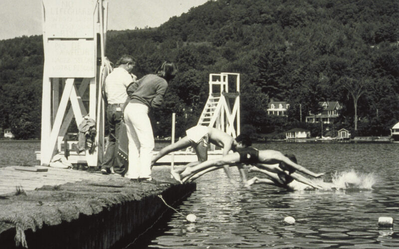 A group of people standing on top of a dock.