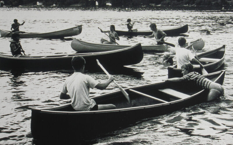 A group of people in canoes on the water.